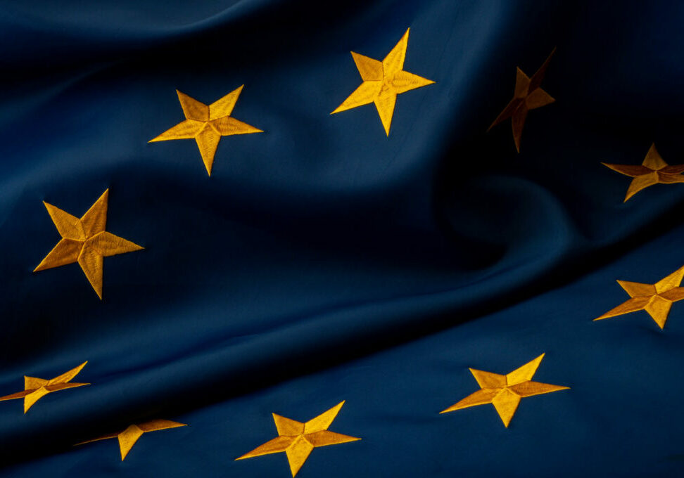 InternationalcollaborationpoliticalunityandeconomicpartnershipconceptEuropeanUnionflagwithyellowstarsonbluebackgroundwith